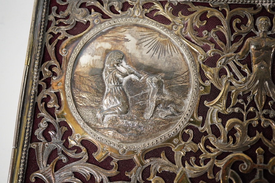 A white metal mounted rectangular desk folder, with beaded borders and pierced and decorated with scrolling foliage, birds and oval panels depicting figures at various pursuits, stamped '13', 30.6cm. Condition - poor to